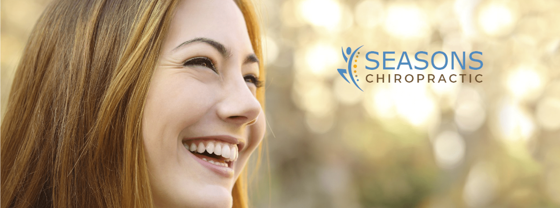 Image: Resilient Recovery - A delighted woman focuses on the Seasons Chiropractic logo, symbolizing strength, joy, and successful recovery from car accidents.